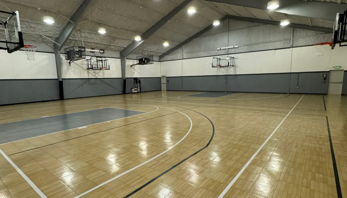 Wide interior view of the Liberty Hill Athletics indoor basketball court